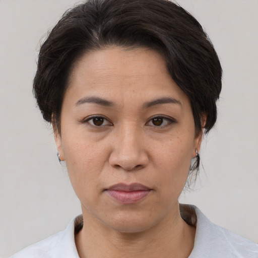 Joyful white adult female with short  brown hair and brown eyes