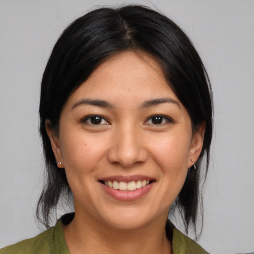 Joyful white young-adult female with medium  black hair and brown eyes