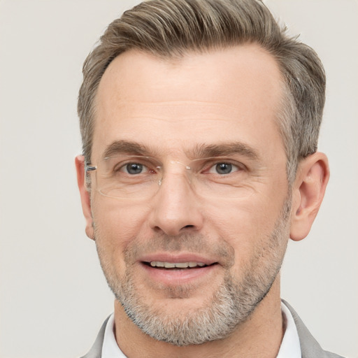 Joyful white adult male with short  brown hair and brown eyes