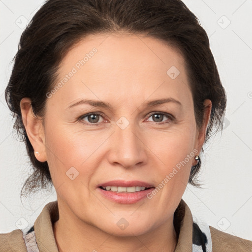 Joyful white adult female with medium  brown hair and brown eyes