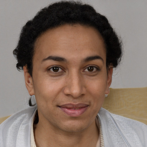 Joyful black young-adult female with short  brown hair and brown eyes