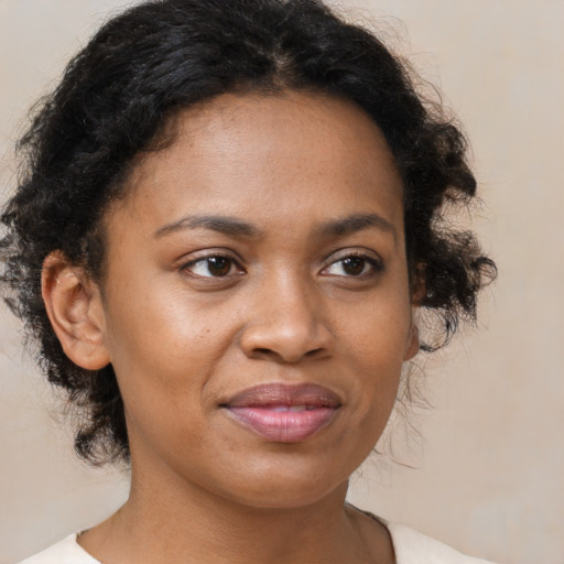Joyful black young-adult female with medium  brown hair and brown eyes