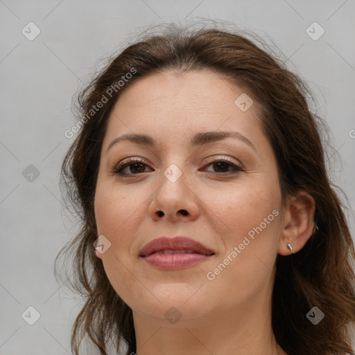 Joyful white adult female with long  brown hair and brown eyes