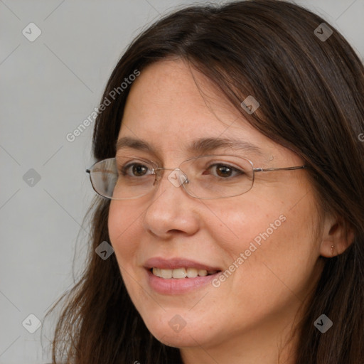 Joyful white adult female with long  brown hair and brown eyes