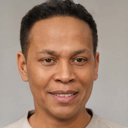 Joyful latino adult male with short  brown hair and brown eyes