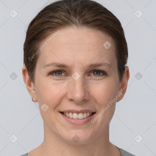 Joyful white adult female with short  brown hair and grey eyes