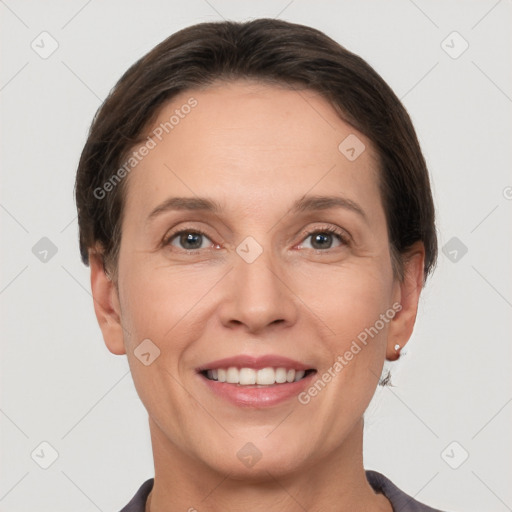 Joyful white adult female with short  brown hair and grey eyes