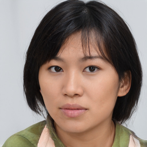 Neutral asian young-adult female with medium  brown hair and brown eyes
