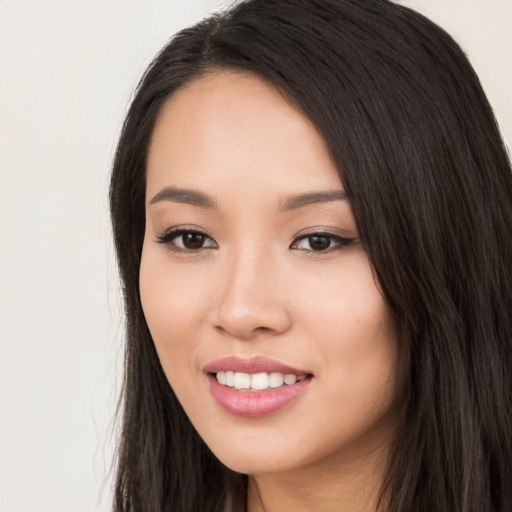 Joyful white young-adult female with long  black hair and brown eyes