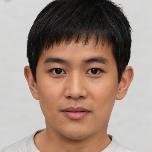 Joyful asian young-adult male with short  black hair and brown eyes