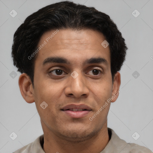 Joyful latino young-adult male with short  brown hair and brown eyes