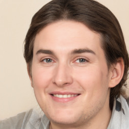 Joyful white young-adult male with medium  brown hair and brown eyes