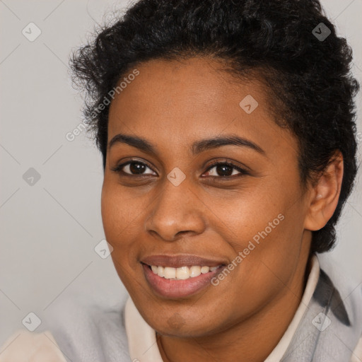 Joyful black young-adult female with short  brown hair and brown eyes