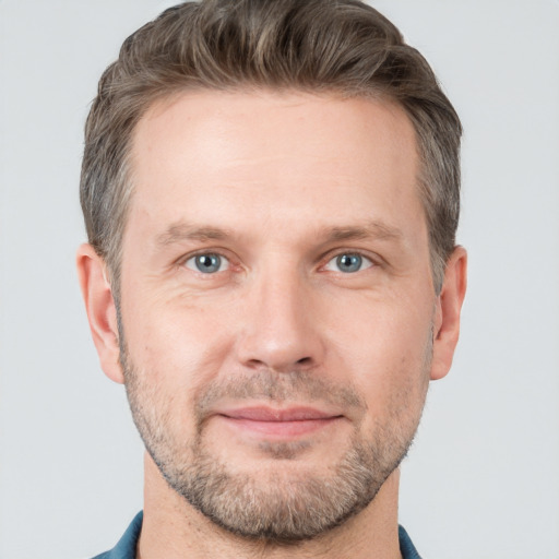 Joyful white adult male with short  brown hair and grey eyes