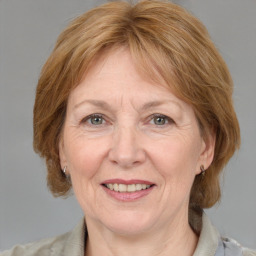 Joyful white adult female with medium  brown hair and blue eyes