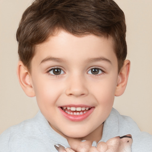 Joyful white child male with short  brown hair and brown eyes