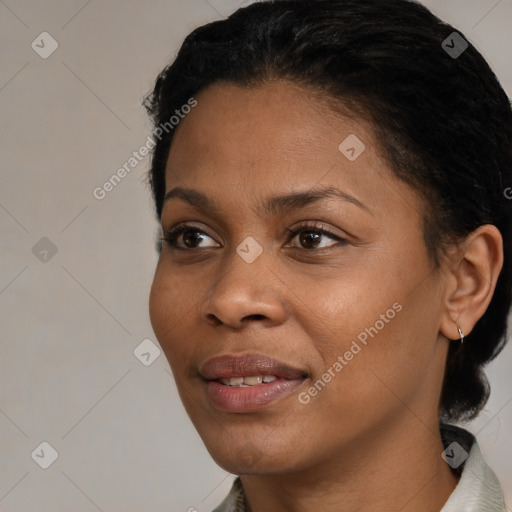 Joyful black young-adult female with short  black hair and brown eyes