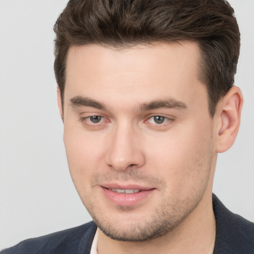 Joyful white young-adult male with short  brown hair and brown eyes