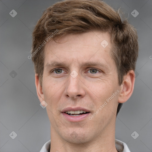 Joyful white adult male with short  brown hair and grey eyes