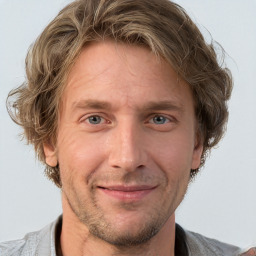 Joyful white adult male with short  brown hair and grey eyes