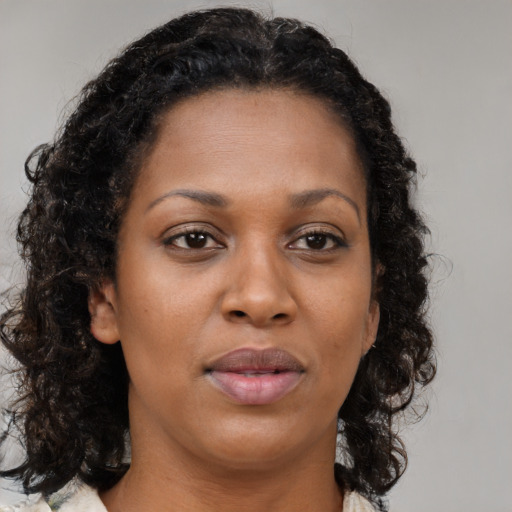 Neutral black adult female with long  brown hair and brown eyes