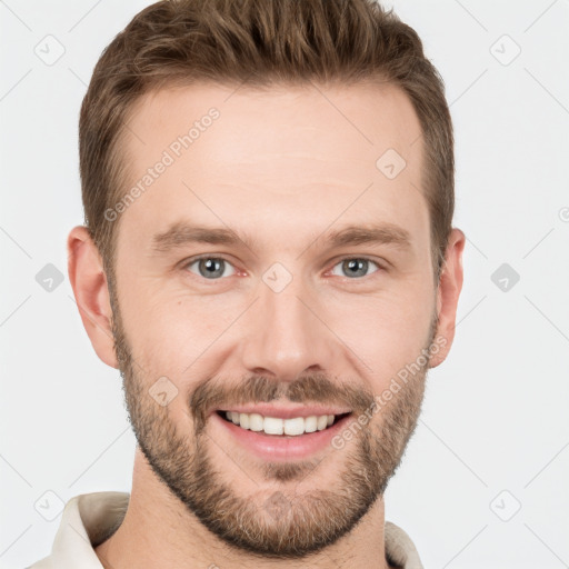 Joyful white young-adult male with short  brown hair and grey eyes