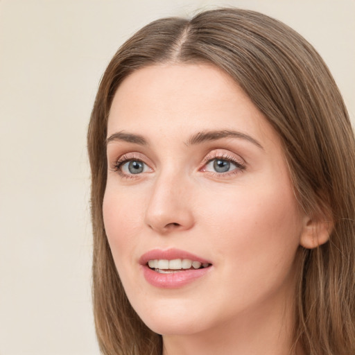 Joyful white young-adult female with long  brown hair and green eyes