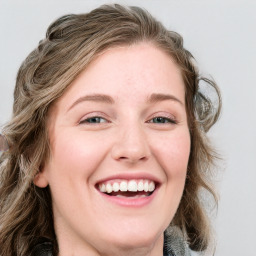 Joyful white young-adult female with medium  brown hair and blue eyes