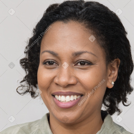 Joyful black adult female with medium  brown hair and brown eyes