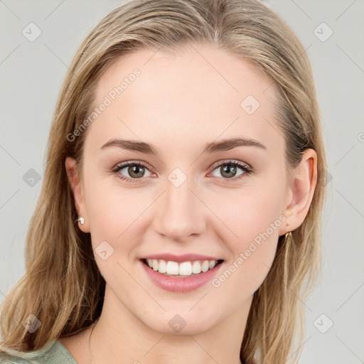 Joyful white young-adult female with long  brown hair and blue eyes