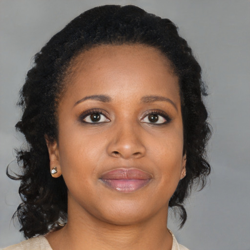 Joyful black young-adult female with medium  brown hair and brown eyes