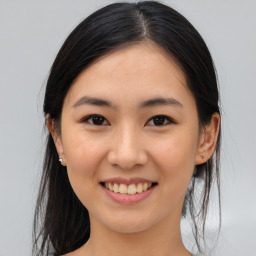 Joyful asian young-adult female with medium  brown hair and brown eyes