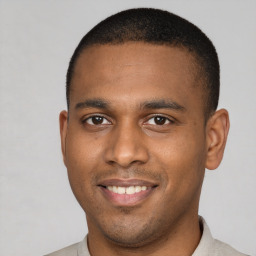 Joyful latino young-adult male with short  brown hair and brown eyes