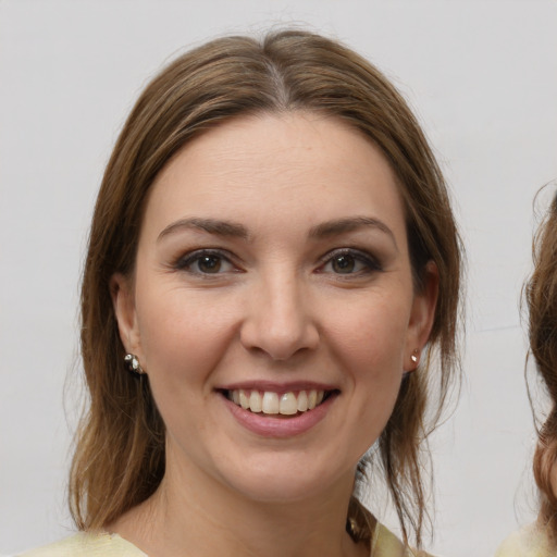 Joyful white young-adult female with medium  brown hair and brown eyes