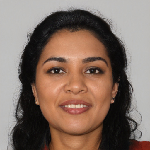 Joyful latino young-adult female with long  black hair and brown eyes
