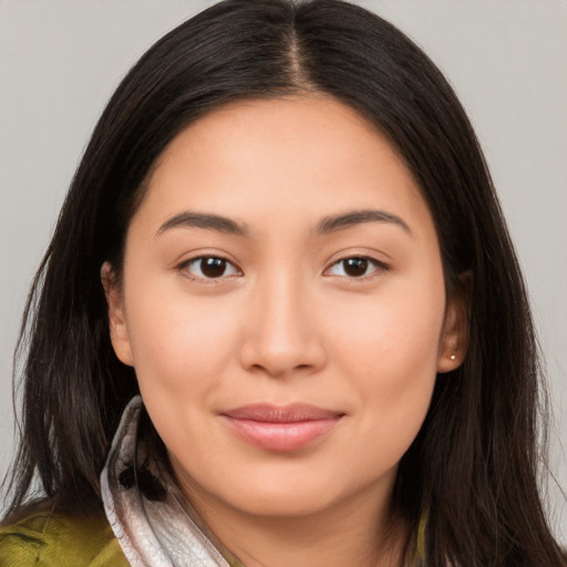 Joyful latino young-adult female with long  brown hair and brown eyes