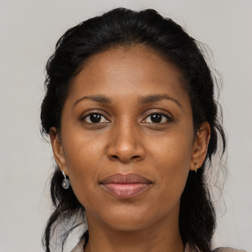 Joyful latino young-adult female with medium  black hair and brown eyes