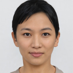 Joyful asian young-adult female with short  black hair and brown eyes