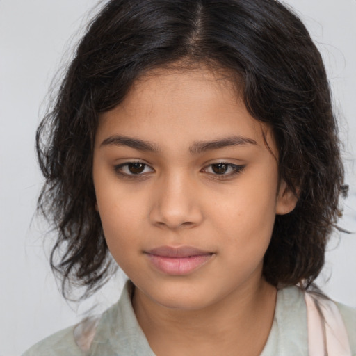 Joyful latino child female with medium  brown hair and brown eyes