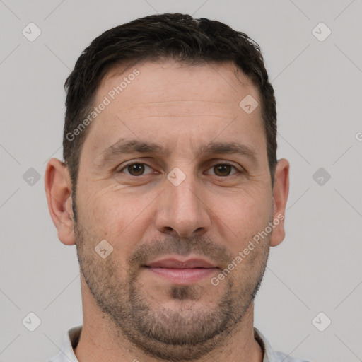 Joyful white adult male with short  brown hair and brown eyes