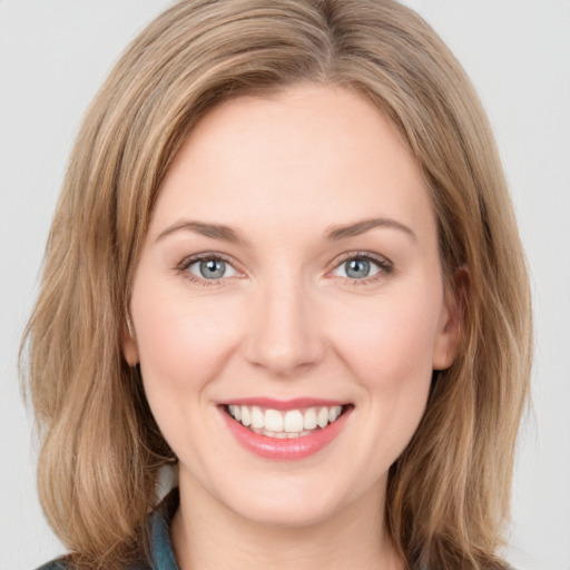 Joyful white young-adult female with medium  brown hair and green eyes