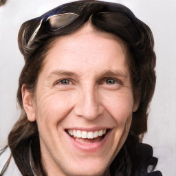 Joyful white adult male with medium  brown hair and grey eyes