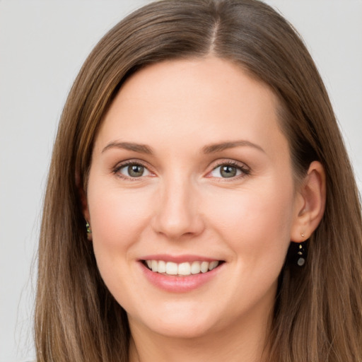 Joyful white young-adult female with long  brown hair and grey eyes