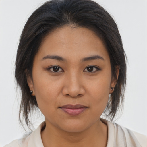 Joyful latino young-adult female with medium  brown hair and brown eyes