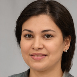 Joyful white adult female with medium  brown hair and brown eyes