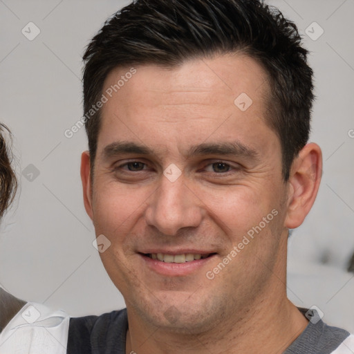 Joyful white adult male with short  brown hair and brown eyes