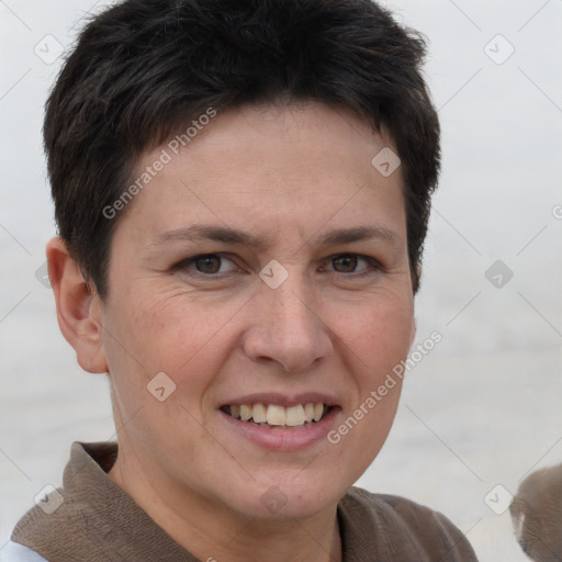 Joyful white adult female with short  brown hair and grey eyes