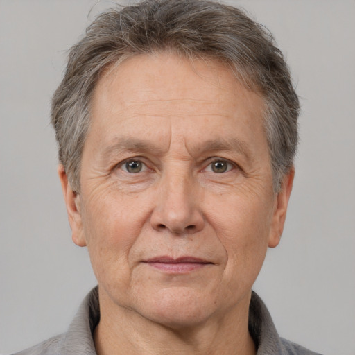 Joyful white middle-aged male with short  gray hair and brown eyes