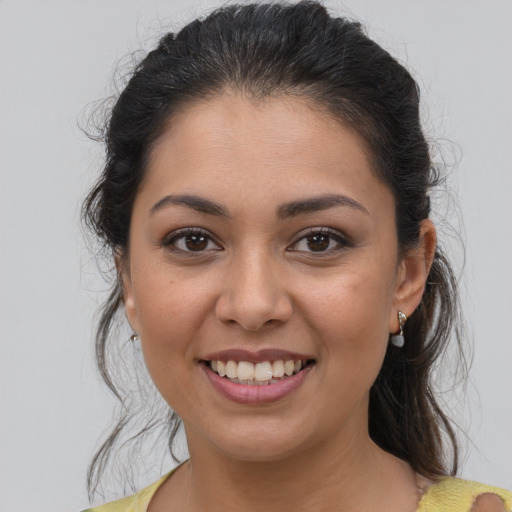 Joyful latino young-adult female with medium  brown hair and brown eyes
