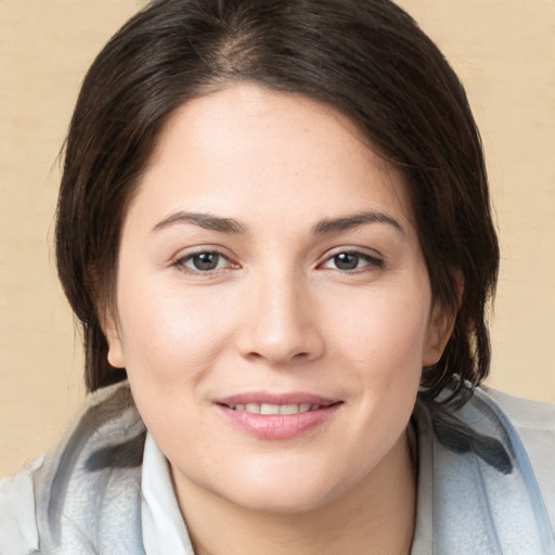 Joyful white young-adult female with medium  brown hair and brown eyes